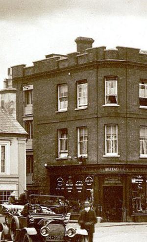 Sid Midgley and car in front of shop